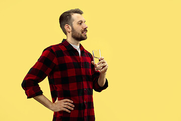 Image showing Half-length close up portrait of young man on yellow background.