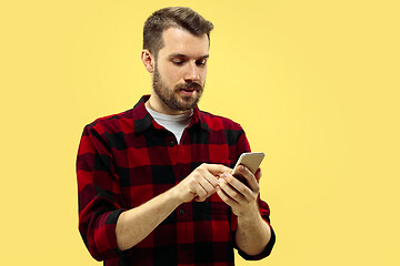 Image showing Half-length close up portrait of young man on yellow background.