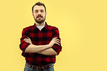 Image showing Half-length close up portrait of young man on yellow background.