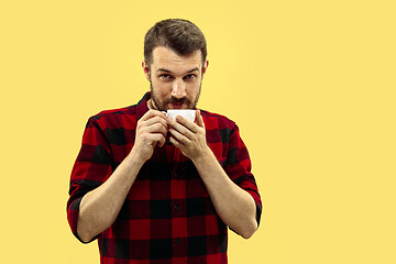 Image showing Half-length close up portrait of young man on yellow background.