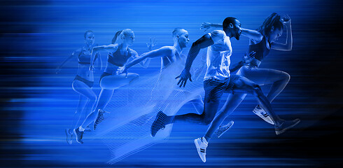 Image showing Young african-american and caucasian men and women running isolated on blue studio background