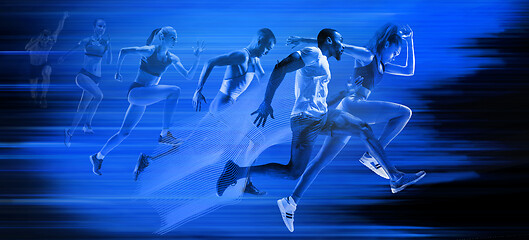 Image showing Young african-american and caucasian men and women running isolated on blue studio background