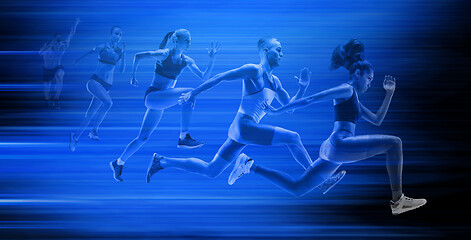 Image showing Young african-american and caucasian man and women running isolated on blue studio background