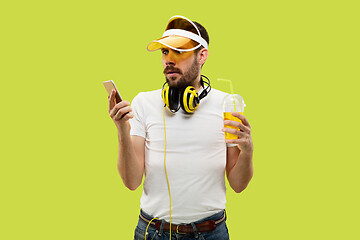 Image showing Half-length close up portrait of young man on yellow background