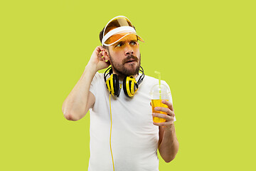 Image showing Half-length close up portrait of young man on yellow background