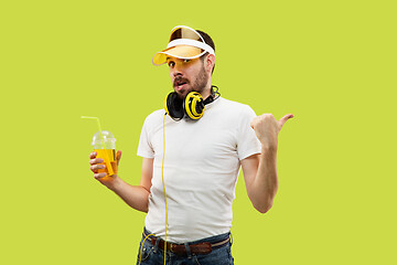 Image showing Half-length close up portrait of young man on yellow background