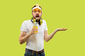 Image showing Half-length close up portrait of young man on yellow background