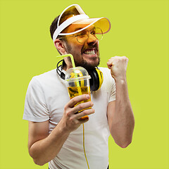 Image showing Half-length close up portrait of young man on yellow background