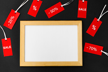 Image showing white board and red tags with discount signs
