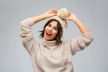 Image showing young woman in knitted winter hat and sweater