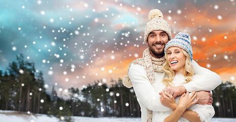 Image showing smiling couple in winter clothes hugging