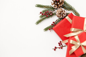 Image showing christmas gifts and fir branches with pine cones