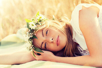 Image showing happy woman in wreath of flowers on cereal field