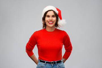 Image showing happy young woman in santa hat on christmas