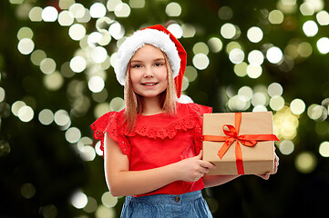 Image showing smiling girl in snata hat with christmas gift