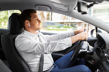 Image showing man or driver with wireless earphones driving car