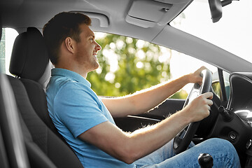 Image showing smiling man or driver driving car