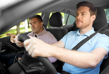 Image showing car driving school instructor teaching male driver
