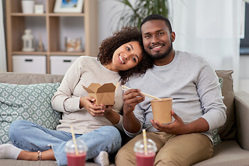 Image showing happy couple with takeaway food and drinks at home