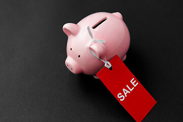 Image showing piggy bank with red sale tag on black