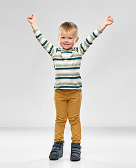 Image showing happy little boy with raised hands