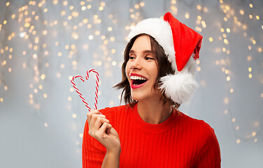 Image showing happy young woman in santa hat on christmas