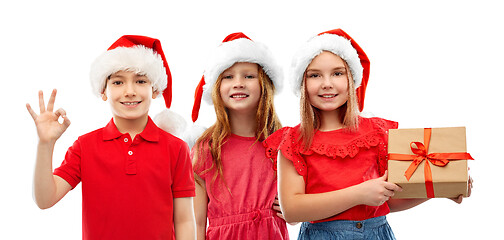 Image showing children in santa helper hats with christmas gift