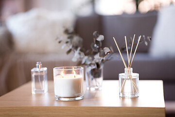 Image showing aroma reed diffuser, burning candle and perfume