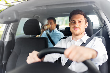 Image showing male driver driving car with passenger