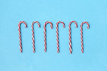 Image showing candy cane decorations on blue background