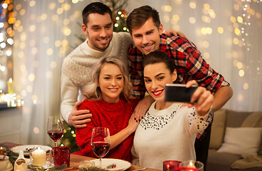 Image showing friends taking selfie at christmas dinner