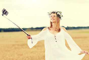 Image showing happy young woman taking selfie by smartphone