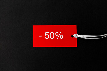 Image showing red tags with discount signs on black background