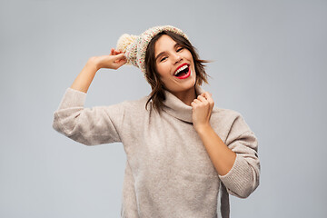 Image showing young woman in knitted winter hat and sweater