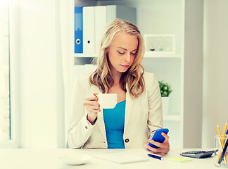 Image showing businesswoman texting on smartphone at office