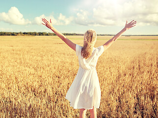 Image showing happy young woman in white dress on cereal field