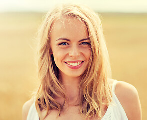 Image showing smiling young woman in white on cereal field