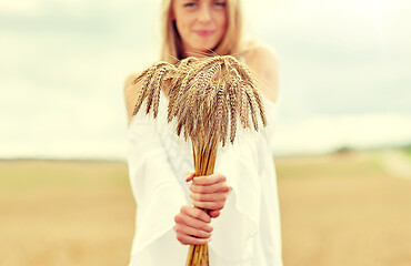 Image showing close up of happy woman with cereal spikelets