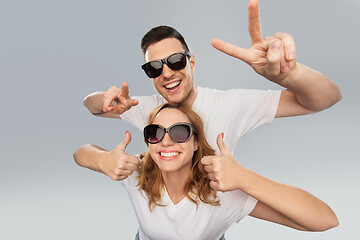 Image showing happy couple in sunglasses showing peace