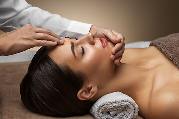 Image showing woman having face and head massage at spa