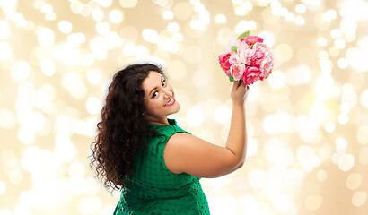 Image showing happy woman in green dress with flower bunch