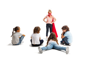 Image showing Child pretending to be a superhero with her friends sitting around