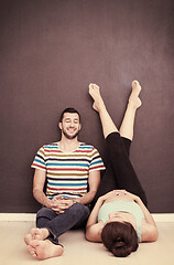 Image showing pregnant couple relaxing on the floor