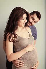 Image showing pregnant couple  isolated over blue background