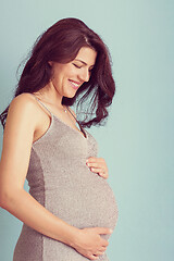 Image showing Portrait of pregnant woman over blue background