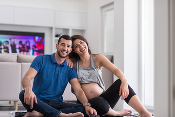 Image showing pregnant couple checking a list of things for their unborn baby