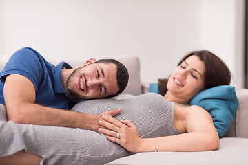 Image showing future dad listening the belly of his pregnant wife