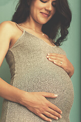 Image showing Portrait of pregnant woman over blue background