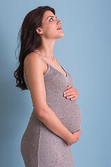 Image showing Portrait of pregnant woman over blue background