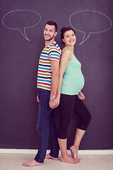 Image showing pregnant couple writing on a black chalkboard